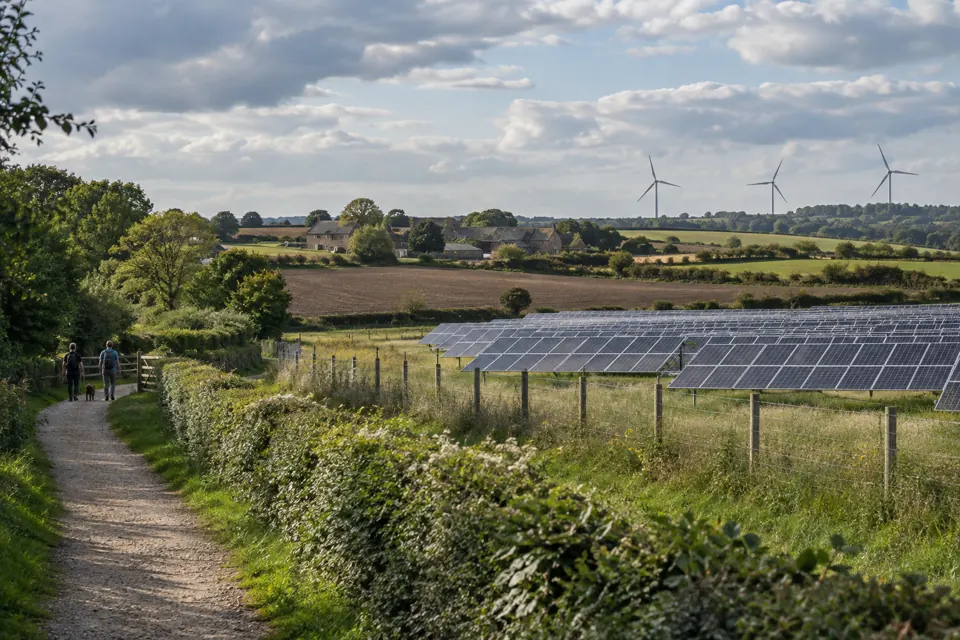 Wind turbines and solar photovoltaic panels integrated alongside agricultural land
